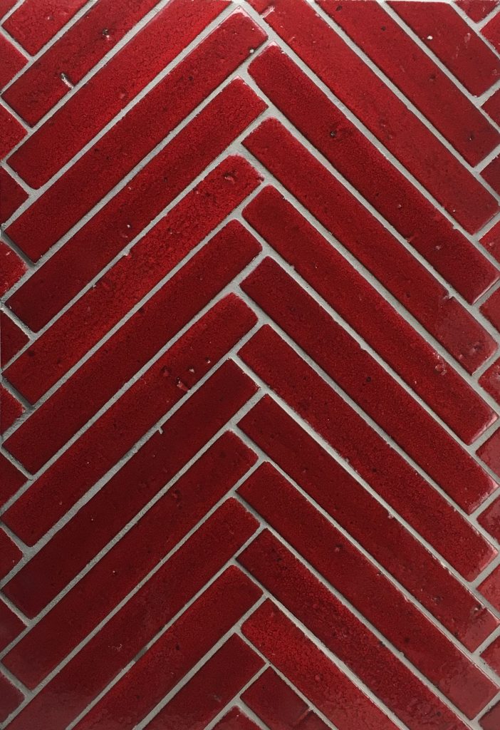 Bison Brick 1x8 Herringbone pattern in glaze Matador.